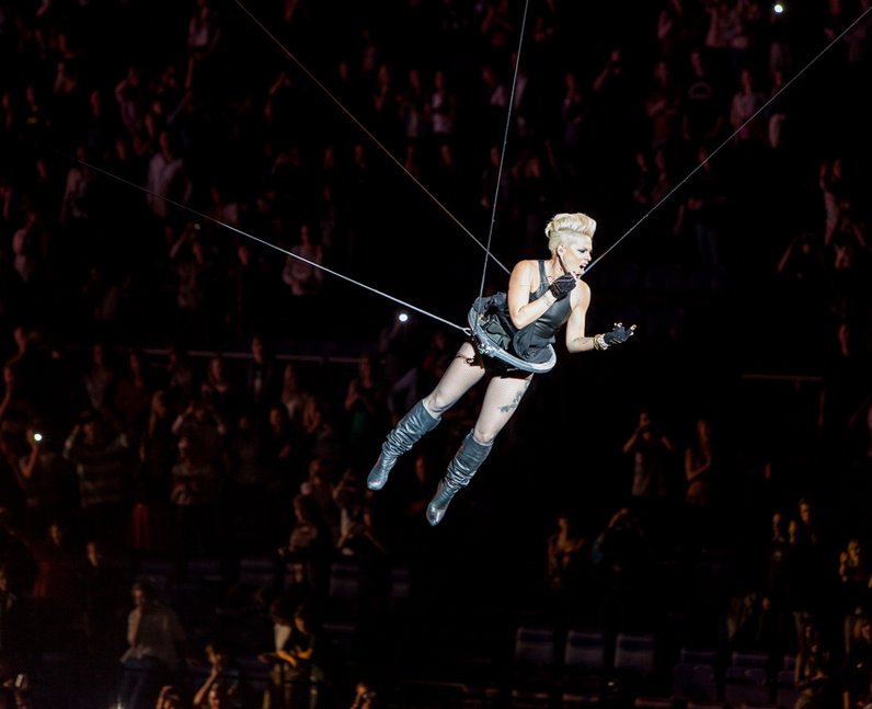 Pink goes flying through the arena in London as she performs her hit