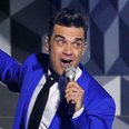 Robbie Williams live on stage at the BRIT Awards 2